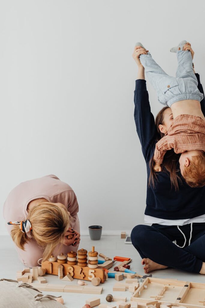 Family enjoying playful moments with children in a cozy indoor setting.